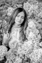 Black and white portrait a sweet girl with stunning curls in a hydrangea garden Royalty Free Stock Photo