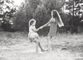 Black and white portrait of Two Happy cute  little girls embracing and dancing at sunny summer day outdoors Royalty Free Stock Photo