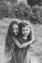 Black and white portrait of Two Happy little girls laughing and hugging at the summer park Royalty Free Stock Photo