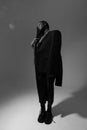 Black and white portrait of young African American woman wearing long dress posing indoor. Vertical. Royalty Free Stock Photo