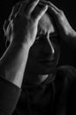 Black and white portrait of a young bald man who with his hands on his head looks desperate Royalty Free Stock Photo