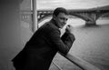 Black and white portrait of young businessman posing on balcony Royalty Free Stock Photo