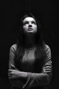 Black and white portrait of a young girl looking up girl with long hair. Woman prying