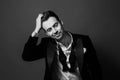 Black and white portrait of a young handsome man in a suit, bow tie and shirt buttons undone. Royalty Free Stock Photo