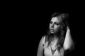 Black and white portrait of young woman brushing hair with hand. Royalty Free Stock Photo