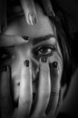 Black and white portrait of a young woman with her face covered with hands, concept for showing the anxieties and fears of women