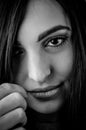 Black and white portrait of a young woman with long brown hair and a captivating and gaze Royalty Free Stock Photo