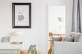 Black and white poster of dog on the wall of fashionable living room interior