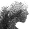 A black and white profile portrait of a woman combined with an image of tropical leaves. Royalty Free Stock Photo