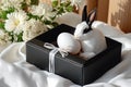 Black and White Rabbit with Easter Egg in a Black Box with White Flowers Royalty Free Stock Photo
