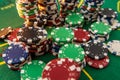 Black white red blue green casino chips stacks on green poker table. Betting club and gamble Royalty Free Stock Photo