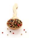 Black, white and red pepper spice on wooden spoon Royalty Free Stock Photo