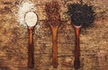 Black, white and red quinoa in spoons, raw quinoa groats assorted, wooden rustic kitchen table, top view Royalty Free Stock Photo