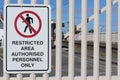 Black, white and red Restricted Area, Authorised Personnel Only warning sign on a fence