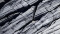 Black white rock texture. Dark gray stone granite background for design. Rough cracked mountain surface. Close-up. Crumbled. Royalty Free Stock Photo