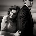 Black and white romantic portrait of the tender charming bride leaning on the back of her handsome lover. Royalty Free Stock Photo