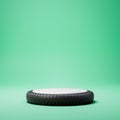 Black and White Rounded Tire Shaped Product Display Pedestal on Green Background