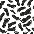 Black and white seamless pattern with doodle foot prints. Royalty Free Stock Photo