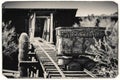 Black and White Sepia Vintage Photo of Goldfield Gold Mine`s old dangerous entrance to a gold mine shaft with trolley Royalty Free Stock Photo