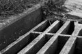 Black and white sewer grate is close Royalty Free Stock Photo