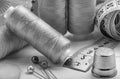 Black and white sewing kit. threads on bobbins, centimeter tape and thimble Royalty Free Stock Photo