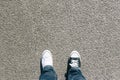 Black and white shoes on asphalt, high angle