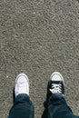 Black and white shoes on asphalt, personal perspective