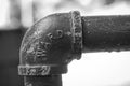 Black and white shot of a bend in lead piping Royalty Free Stock Photo