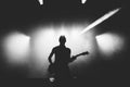 Black and white shot of guitarist silhouette in a stage backlights Royalty Free Stock Photo