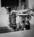 Black and white shot of man repairing heating system