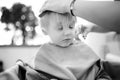 Black and white shot of preschooler boy getting haircut Royalty Free Stock Photo