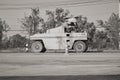 Black and White Side View Five Wheel Road Roller Working on Asphalt Road