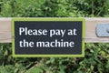 Black and white sign with a green border saying Pleas pay at machine Royalty Free Stock Photo