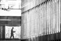 Silhouette of a man reading a newspaper in the architecture of the city