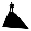 Black and white silhouette of a man who stands in a confident pose of the winner  on top of a mountain. The concept of success in Royalty Free Stock Photo