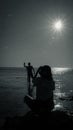 Black and white silhouette man and woman at the beach sea ocean in the morning Royalty Free Stock Photo