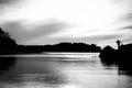 Black and white silhouette of person on Beach Jetty Royalty Free Stock Photo