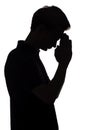 Black and white silhouette portrait of an unrecognizable man in stree, guy face profile dropping his head down and praying on a Royalty Free Stock Photo