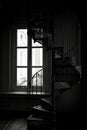 Black and white silhouette of a Victorian era wrought cast iron spiral staircase in a restored building, Singapore