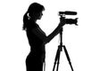 Black and white silhouette of the woman standing next to the video equipment and work with it Royalty Free Stock Photo