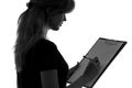 Black and white silhouette of a woman working in an office with a folder for sheets and a pen in the hands Royalty Free Stock Photo