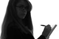 Black and white silhouette of a woman working in an office with a folder for sheets and a pen in the hands Royalty Free Stock Photo