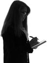 Black and white silhouette of a woman working in an office with a folder for sheets and a pen in the hands Royalty Free Stock Photo