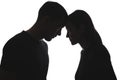 Black and white silhouettes of portraits men and women on white background stand opposite each other, touching their foreheads.