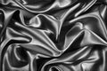 Black white silk satin background. Wavy soft folds on shiny fabric. Silver luxury background for design. Royalty Free Stock Photo