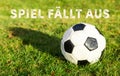 Black white soccer ball with grass german text spiel fÃÂ¤llt aus, in english game fails