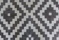 Black and white soft rug in moroccan style. Textile carpet. Abstract texture background with geometric diamond pattern.
