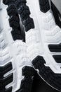 The black and white sole of trendy sports sneakers is a close-up in full screen.
