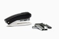 Black and white stapler and paper clip on white background