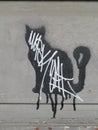 Black and white stencil graffiti cat on cement